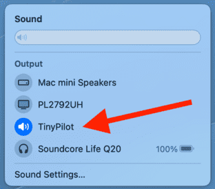 The macOS Control Center displays a list of sound output devices. 'TinyPilot' is selected.