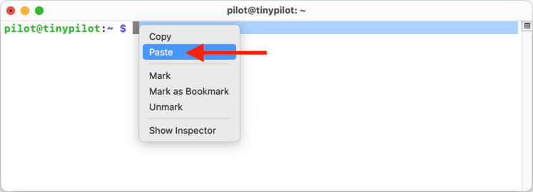 A terminal window displays an SSH connection to a TinyPilot. The right-click menu has been opened near the prompt, with the 'Paste' menu item highlighted, ready to be chosen.