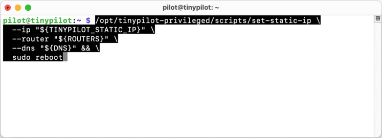 A terminal window displays an SSH connection to a TinyPilot. A group of commands have been pasted into the prompt, ready to be run.