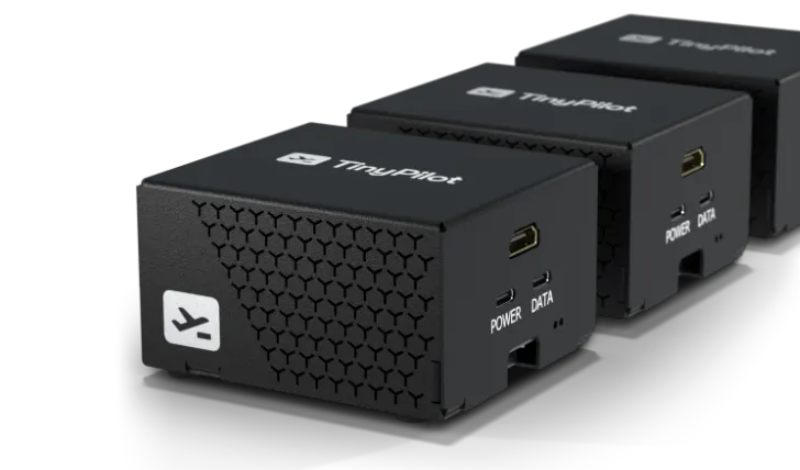 A photo showing three TinyPilot devices arranged side-by-side.