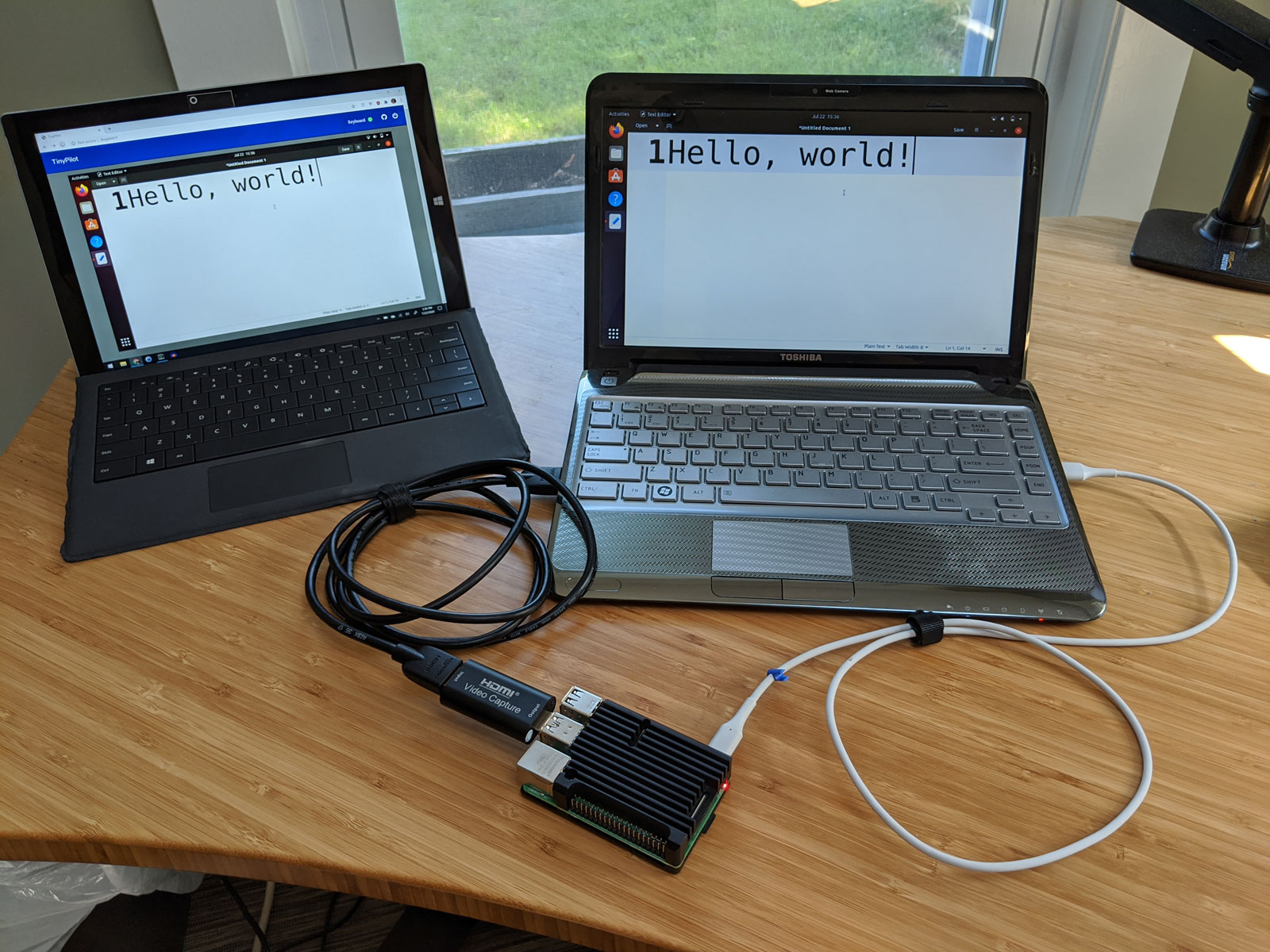 Photo of TinyPilot connecting two computers